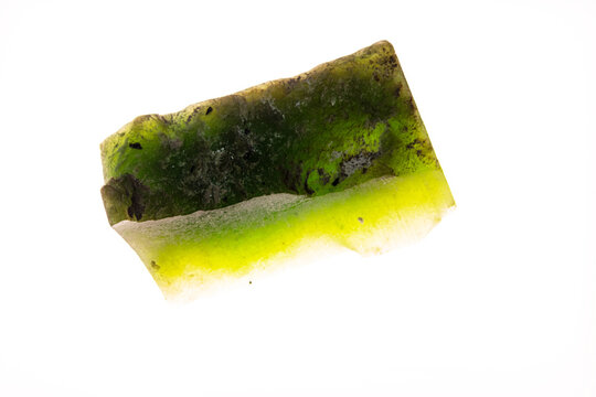 Closeup unpolished slice of nephrite jade natural mineral stone isolated on white background
