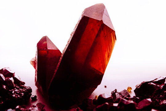 Back-light amber-colored and black crystal quartz stone minerals on white background