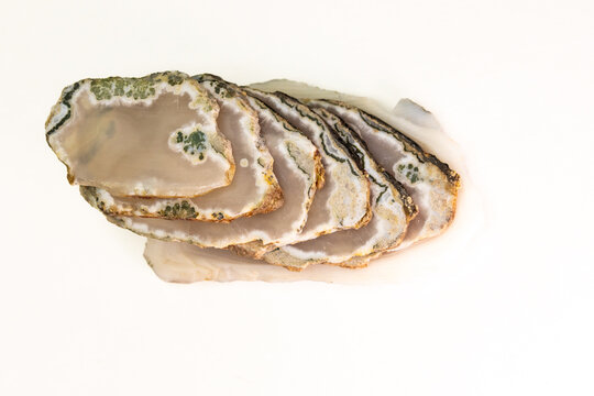 Top view of a pile of smoky agate slices isolated on white background
