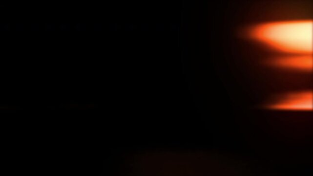 Light flare transition with warm orange and red hues, creating a dynamic visual effect. This footage is ideal for adding a cinematic flair or transition element to videos.