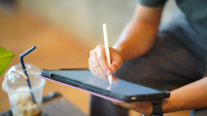 Digital tablet stylus hand drawing artist creative technology screen showing person sketching on portable device indoors © Oporty786