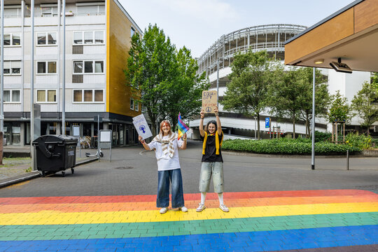 Protest for equality and inclusion on an urban rainbow crosswalk