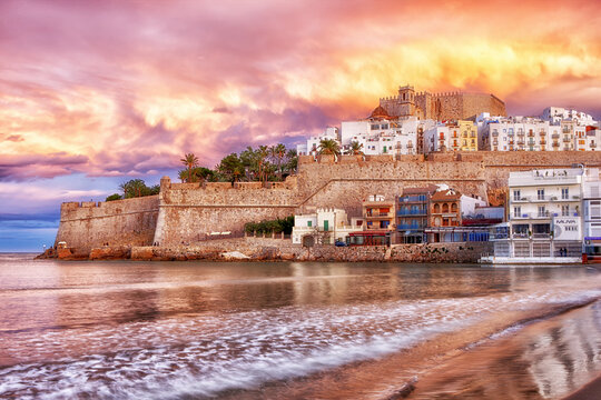 Spain, Province of Castellon, Peniscola, Costa del Azahar, Old town with castle, dramatic sky in the evening