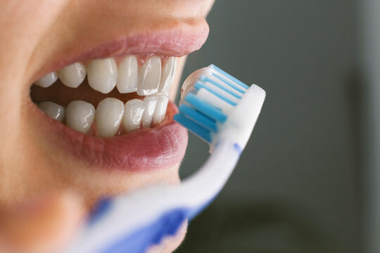 Young woman brushing teeth
