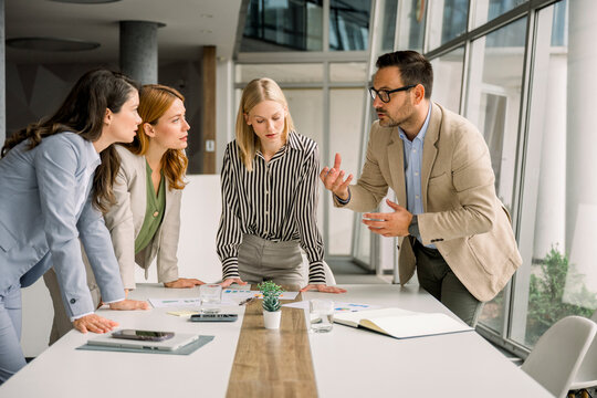 Business team discussing project during meeting in modern office
