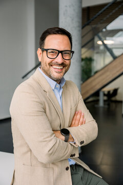 Confident businessman smiling indoors at the modern office