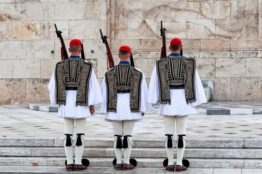 Traditional Evzones guards standing in ceremonial uniform in Athens, Greece. Iconic symbol of Greek history, heritage and national identity near the Hellenic Parliament.