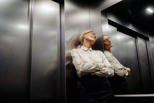 Exhausted businesswoman in elevator