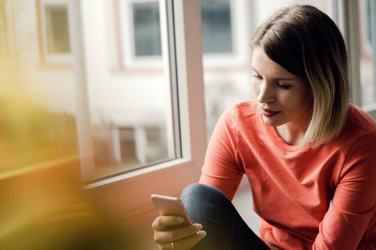 Woman using smartphone at home