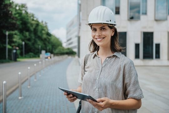 Architect holding tablet PC at construction site