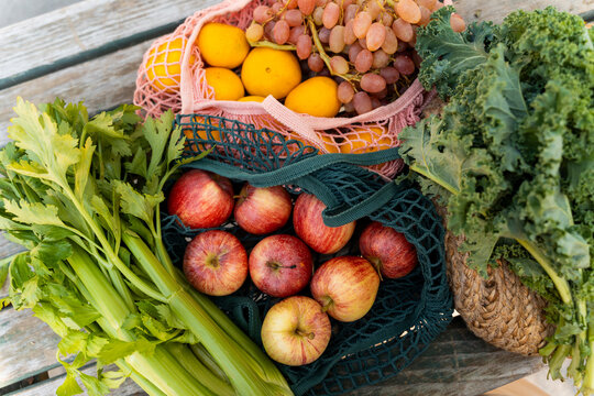 Mesh bags with organic fruit and vegetables at farmer's market
