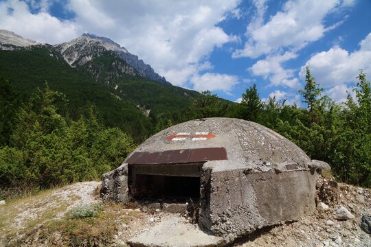 Concrete bunker in Theth. Summer landscape of Theth Mountains in Albanian Alps (also known as Accursed Mountains). Alps of Albania National Park.