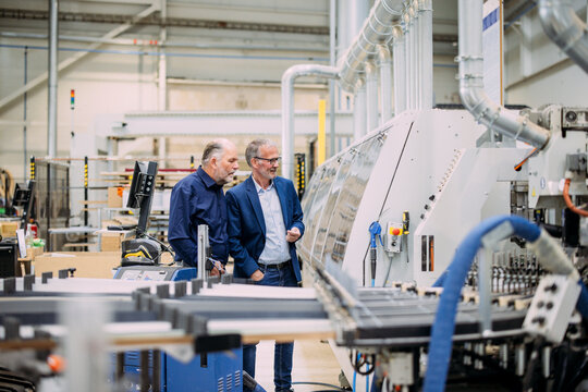 Engineers inspecting machinery in a modern factory setting