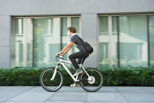 Business commuter riding electric bicycle outdoors in Bavaria