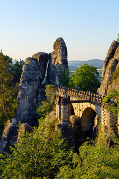 Germany, Saxony, Elbe Sandstone Mountains, view to the Bastei rock formation at sunrise with Bastei Bridge