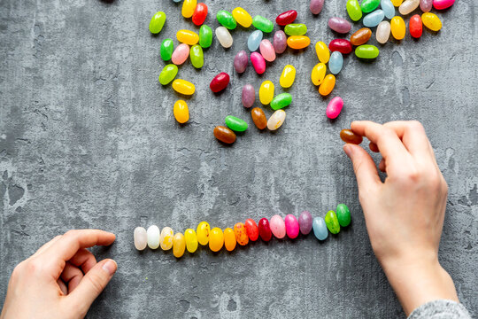 Row of colourful sweet jellybeans on gray background