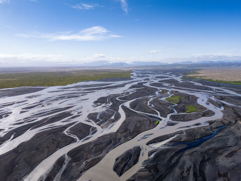 Aerial view of a braided glacial river on volcanic sand in Iceland