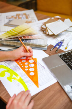 Architect drafting blueprint during online design consultation