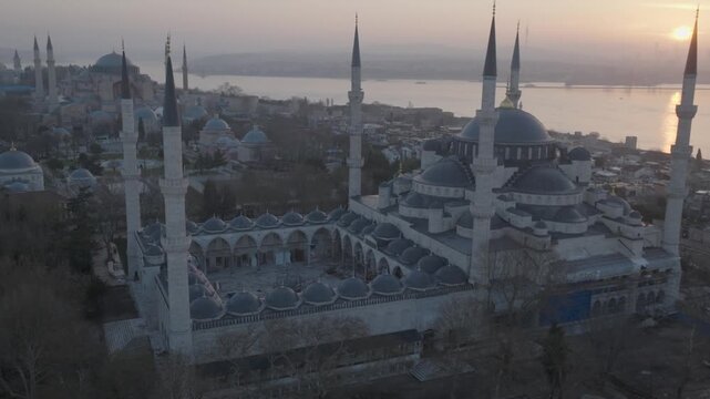 Drone view of the Blue Mosque in Istanbul at sunset. The iconic Ottoman landmark dominates the historic skyline overlooking the Bosphorus.