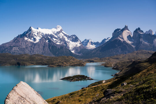 Snow capped mountain peak and turquoise lake in Patagonia Chile