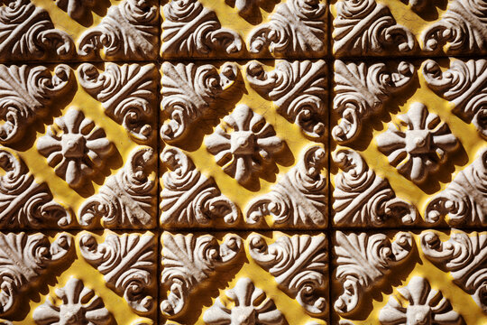 Traditional yellow artisanal relief tile wall pattern in Portugal