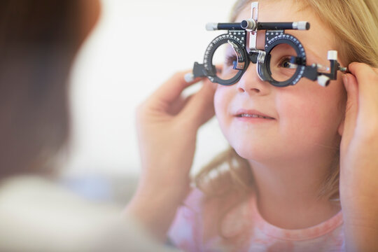 Eye doctor examining girl's vision