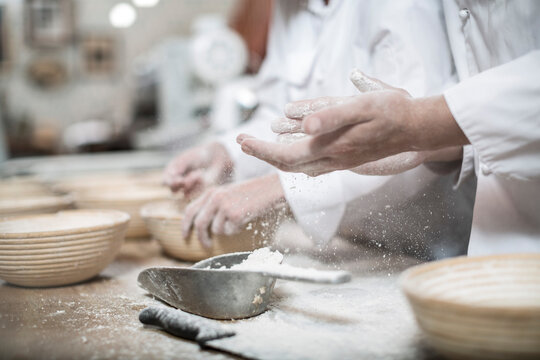 Baker preparing ceramic bowls for baking bread