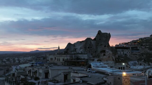 Drone view of Ortahisar Castle towering above the historic town of Ortahisar in Cappadocia, Turkey. A remarkable example of rock-carved architecture.