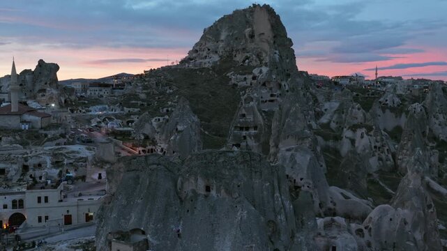 Drone view of Ortahisar Castle towering above the historic town of Ortahisar in Cappadocia, Turkey. A remarkable example of rock-carved architecture.