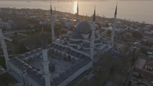 Drone view of the Blue Mosque in Istanbul at sunset. The iconic Ottoman landmark dominates the historic skyline overlooking the Bosphorus.