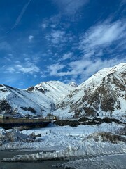Snow-covered mountains and clear blue sky create stunning winter landscape background © dvoevnore