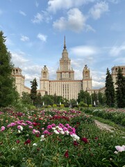 Moscow state university main building with colorful garden and blue sky in summer background © dvoevnore