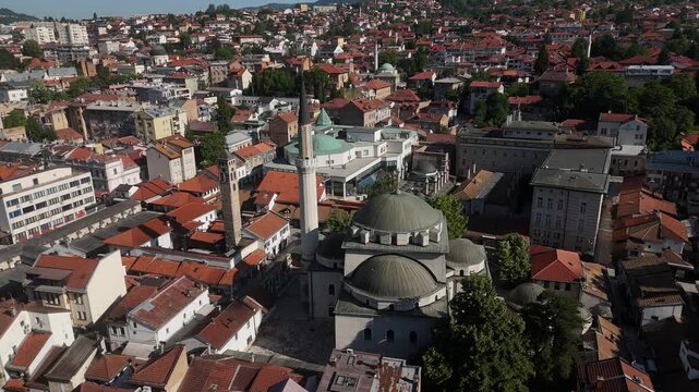 Cinematic Drone Orbit of Gazi Husrev-beg Mosque and Clock Tower at Sunset, Aerial View with Elevation Loss Over Ba&scaron;čar&scaron;ija Old Town in Sarajevo Bosnia, 4K