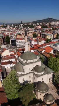 Vertical Drone Orbit of Gazi Husrev-beg Mosque in Sarajevo, Aerial View with Elevation Loss over Historic Bascarsija Old Town and City Center in Bosnia, 4K
