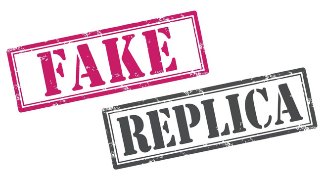 Close-up of two rubber stamps with the words fake and replica in bold letters on white background