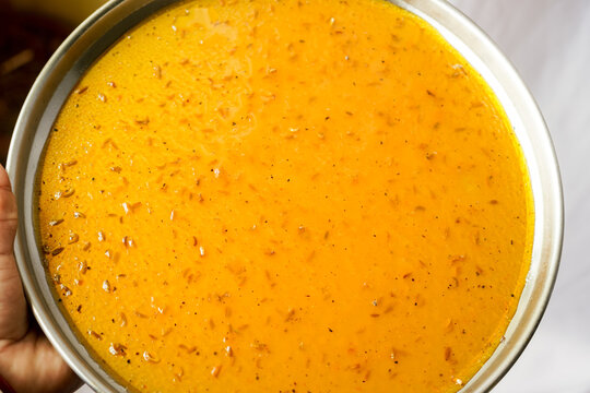 Tasty Amsotto, a traditional Bengali mango bar (Aam Papad) on a steel plate. Sweet sun-dried mango fruit leather Homemade mango papad or amm papad