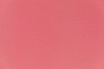 Fototapeta premium Flat solid pink textured plaster wall surface providing a vibrant and empty backdrop. Minimalist modern design, abstract vibrant background, blank canvas, Valentine's Day.
