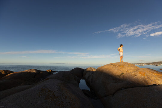 pre teen boy exploring boulders, Shelley Point, Saldanah Bay, Western Cape, South Africa