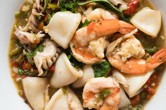 Close-Up of Homemade Pad Krapow (Thai Holy Basil Stir-Fry) with Shrimp and Squid, a Spicy and Appetizing Thai Seafood Dish