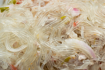 Close-Up of Yum Woon Sen (Thai Glass Noodle Salad) with Minced Pork, Appetizing Food Concept © Latthaphon