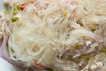 Close-Up of Yum Woon Sen (Thai Glass Noodle Salad) with Minced Pork, Appetizing Food Concept © Latthaphon