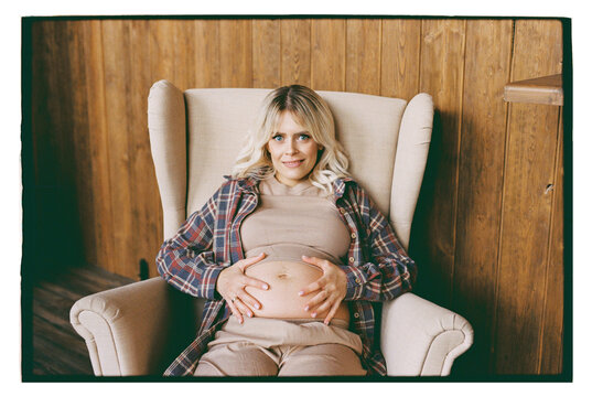 A pregnant woman is resting in a chair
