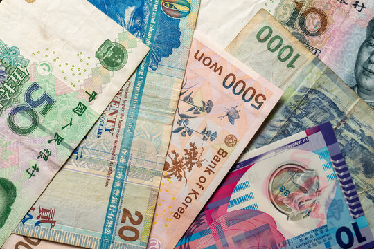 Assorted Asian banknotes overlapping in diagonal layout