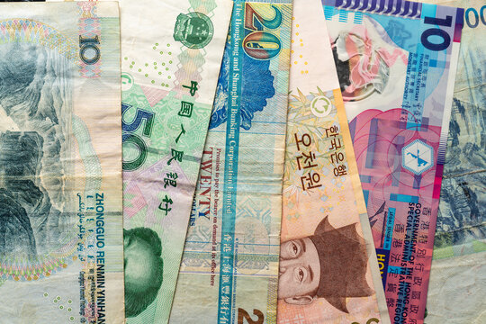 Overlapping Asian banknotes with detailed patterns close-up