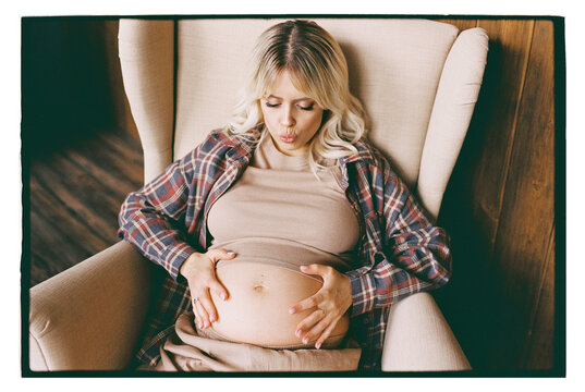 A pregnant woman is resting in a chair