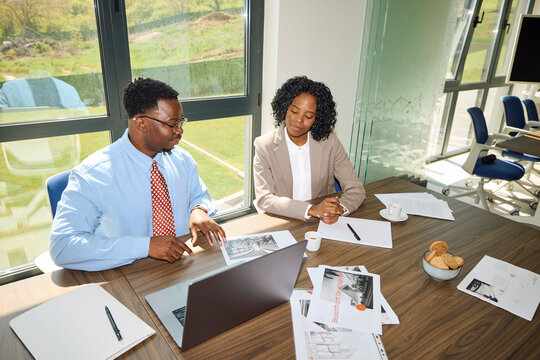 Man and woman engaged in a joint work at the office