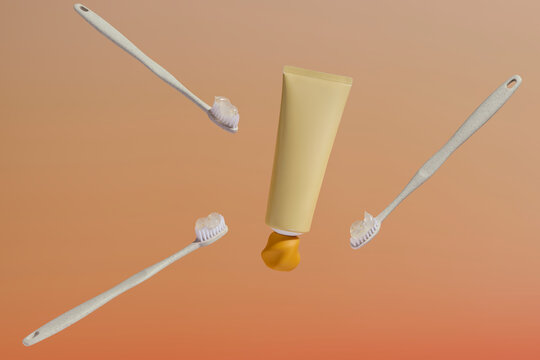 A minimalist composition with white toothbrushes and yellow toothpaste