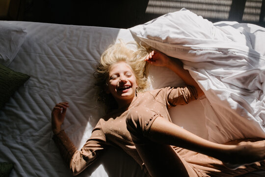 Smiling girl in bed in the morning
