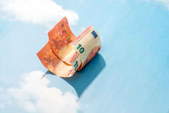 Curved ten euro banknote on blue sky background

