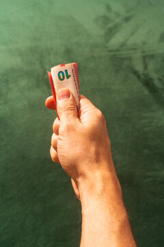 Hand holding folded euro banknotes close-up